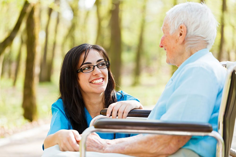 Nurse chatting with a elderly man