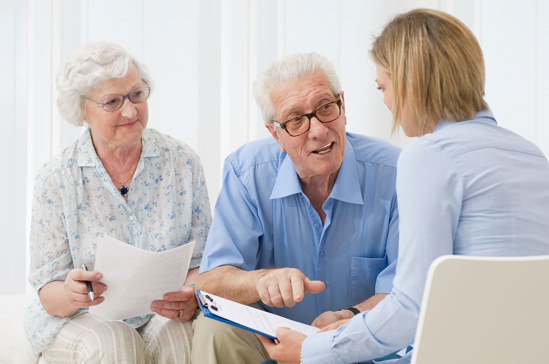 Elderly couple consulting a healthcare professional