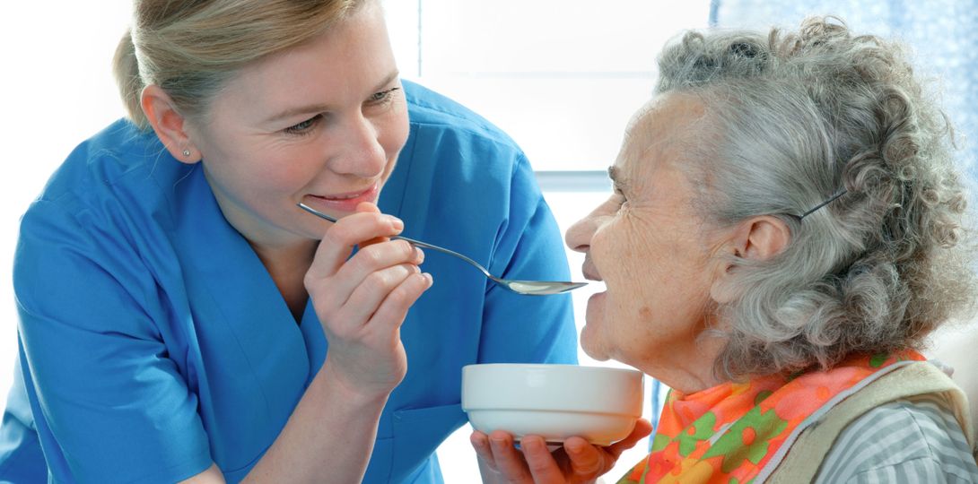 Elderly gentleman being aided by a healthcare